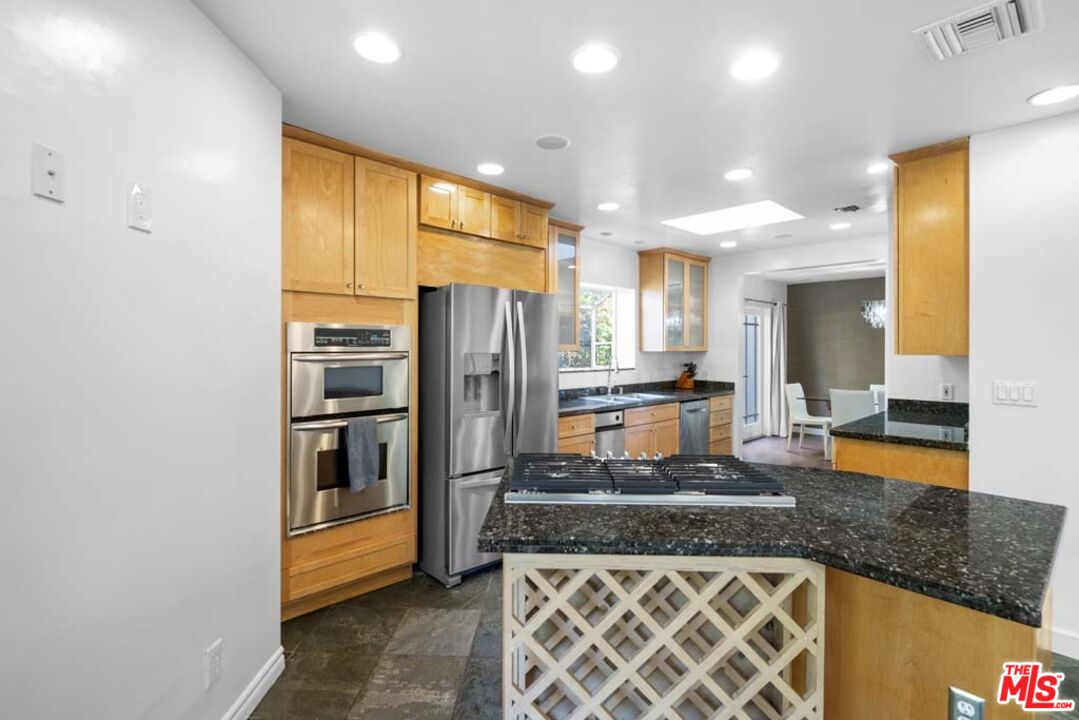 10453 Holman Avenue Los Angeles, CA 90024 - Photo 23 of 67 a kitchen with stainless steel appliances granite countertop a refrigerator and a stove