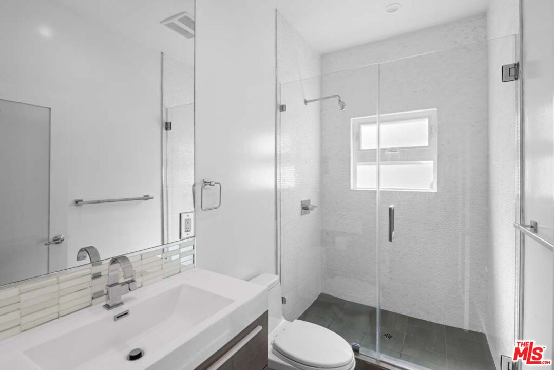 10453 Holman Avenue Los Angeles, CA 90024 - Photo 28 of 67 a bathroom with a sink toilet a mirror and shower
