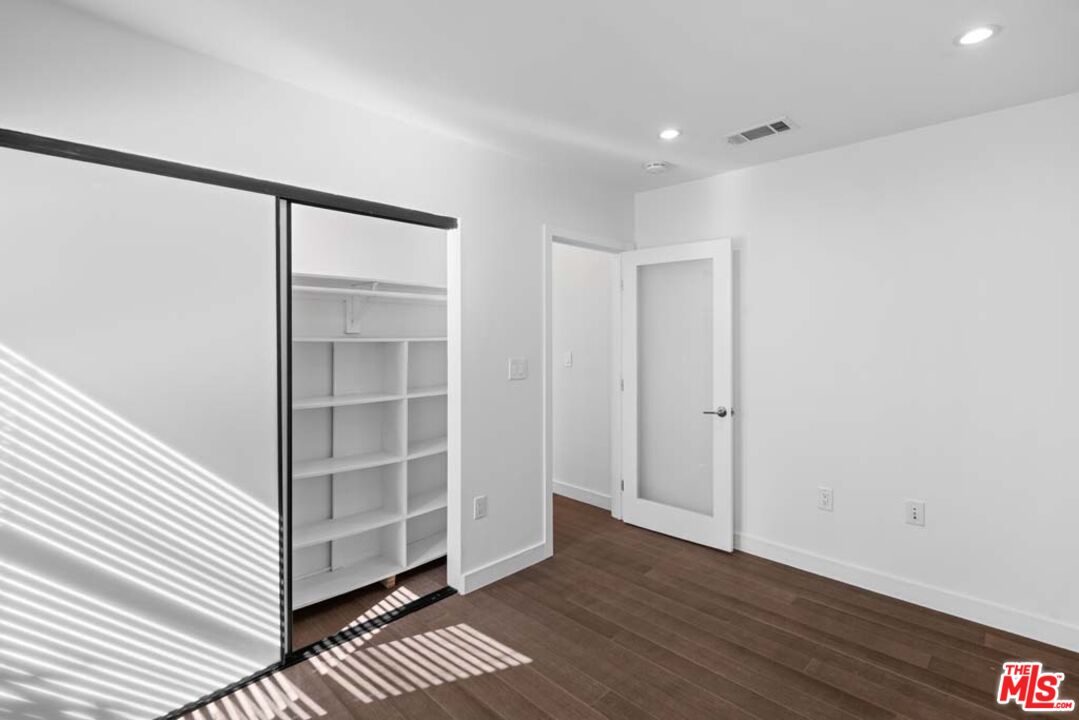 10453 Holman Avenue Los Angeles, CA 90024 - Photo 30 of 67 a view of an empty room with wooden floor and a cabinet