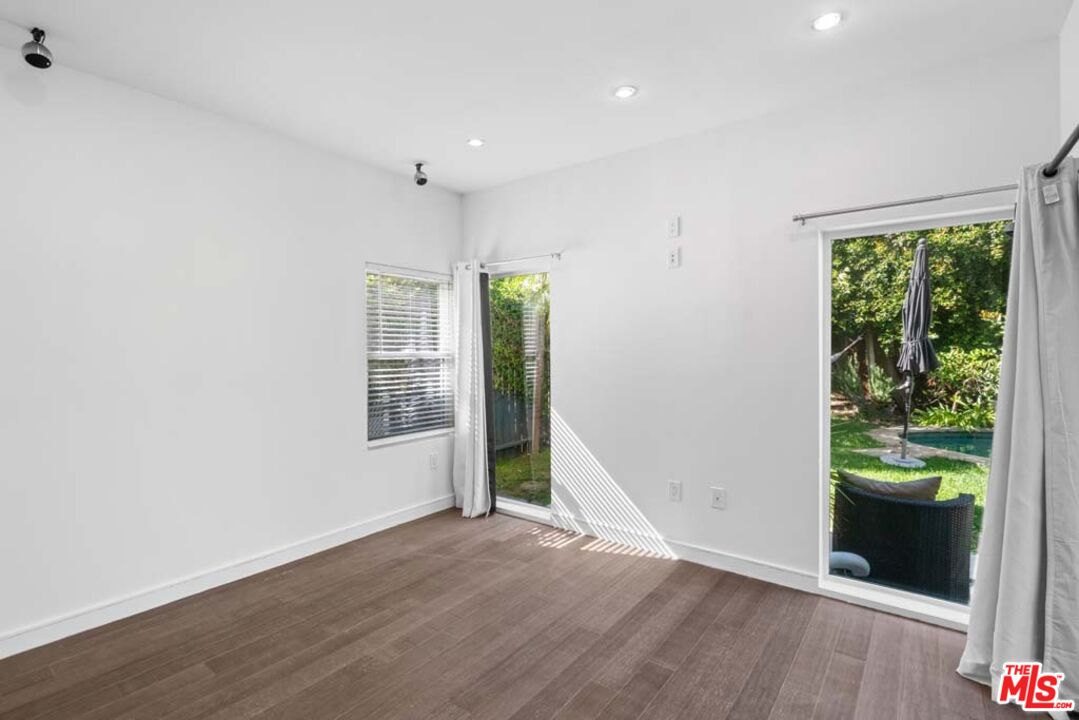 10453 Holman Avenue Los Angeles, CA 90024 - Photo 31 of 67 an empty room with wooden floor and a window