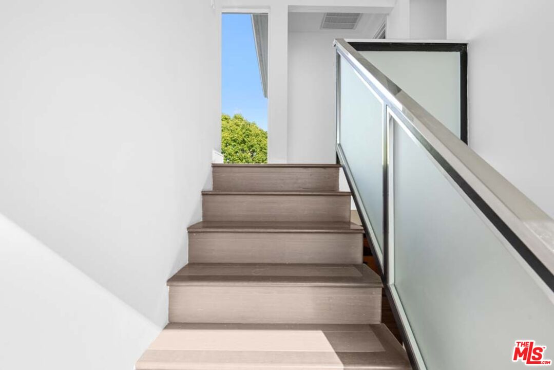 10453 Holman Avenue Los Angeles, CA 90024 - Photo 35 of 67 a view of staircase with white walls and railing