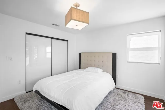 a bedroom with a bed and window