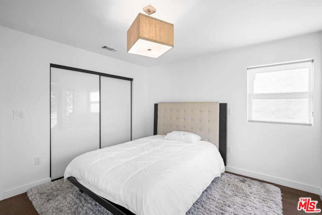 10453 Holman Avenue Los Angeles, CA 90024 - Photo 37 of 67 a large bed sitting in a bedroom next to a window