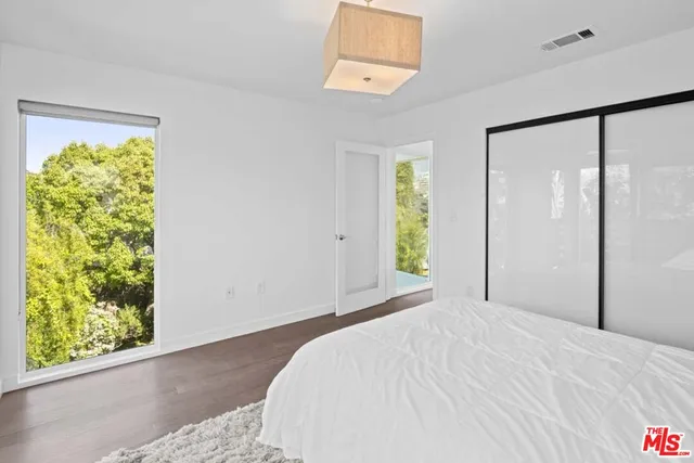 a view of an empty room with window and fire place