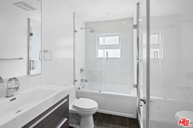 a bathroom with a shower and a sink