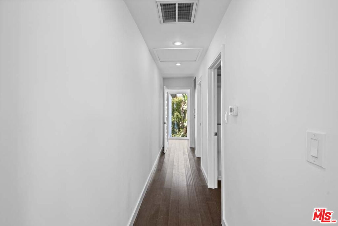 10453 Holman Avenue Los Angeles, CA 90024 - Photo 46 of 67 a view of a hallway with wooden floor and a bathroom