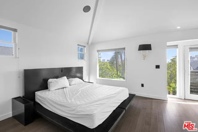 a view of a backyard with plants and a fountain