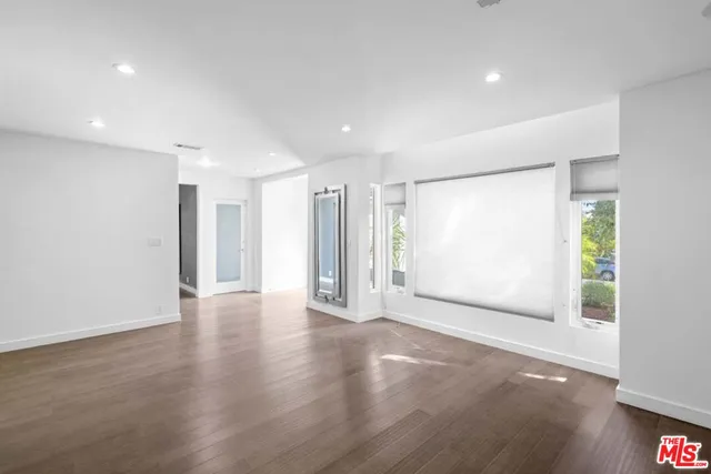 a dining room with furniture a chandelier and wooden floor