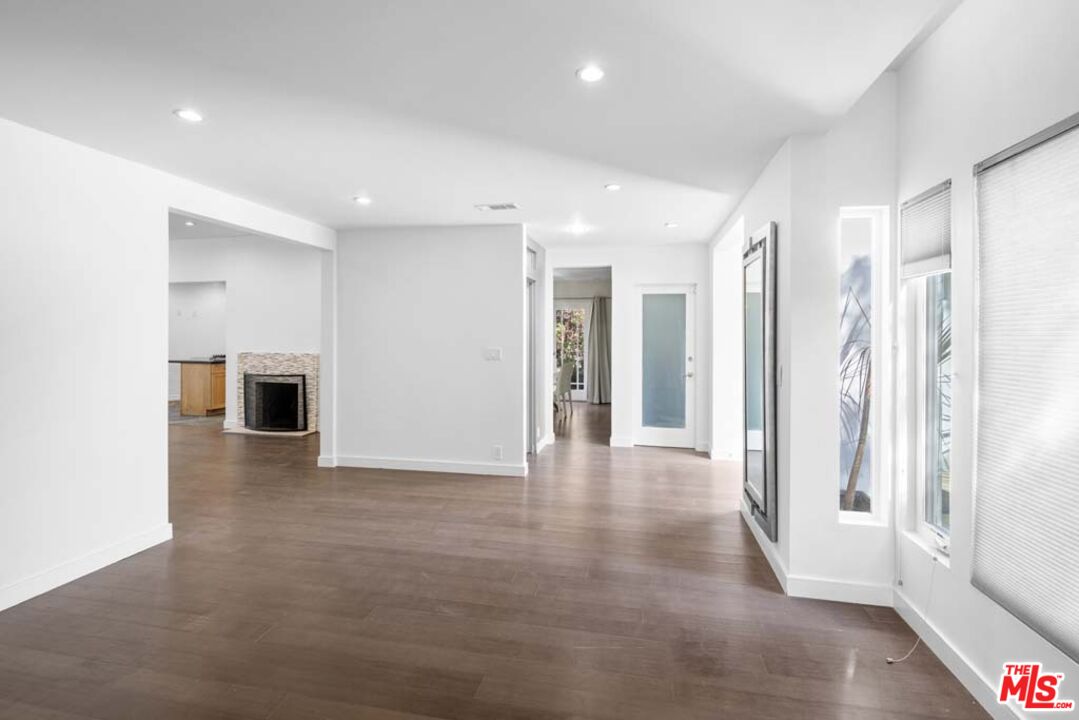 10453 Holman Avenue Los Angeles, CA 90024 - Photo 9 of 67 a view of a hallway with wooden floor and a fireplace