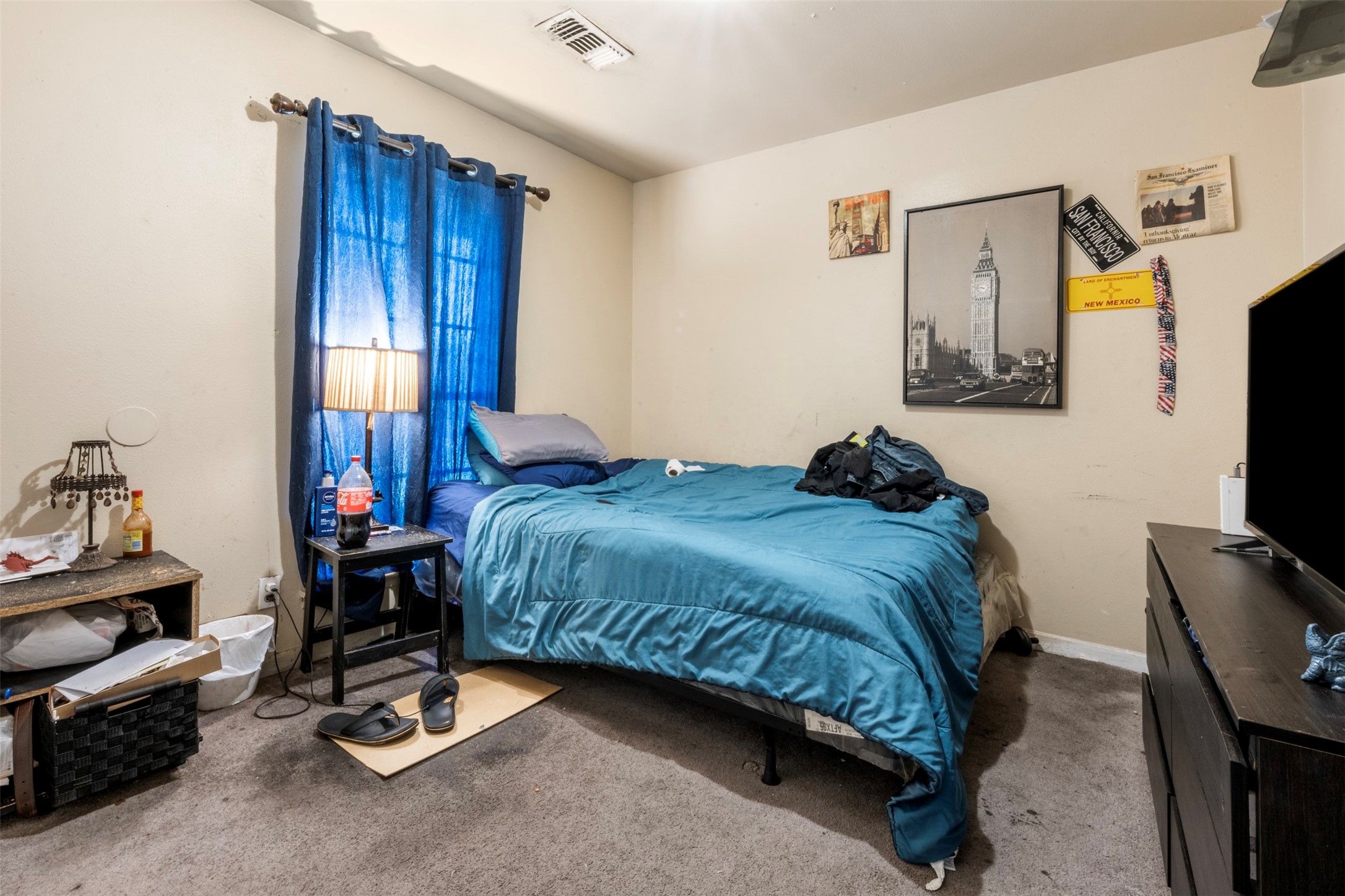 7726 Boggess Road Houston, TX 77016 - Photo 14 of 30 a bedroom with a bed a flat screen tv and dresser