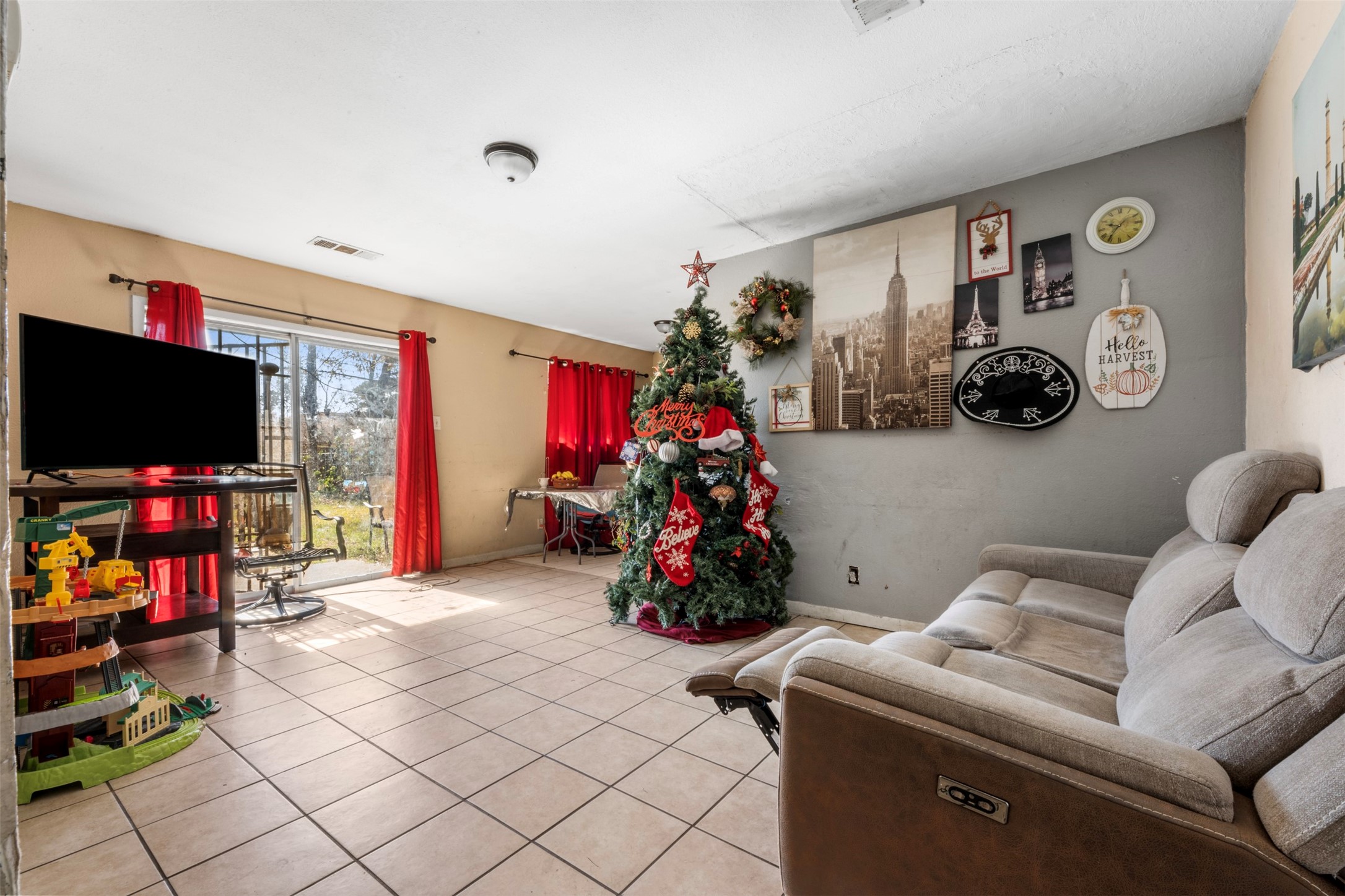 7726 Boggess Road Houston, TX 77016 - Photo 3 of 30 a living room with furniture and a flat screen tv