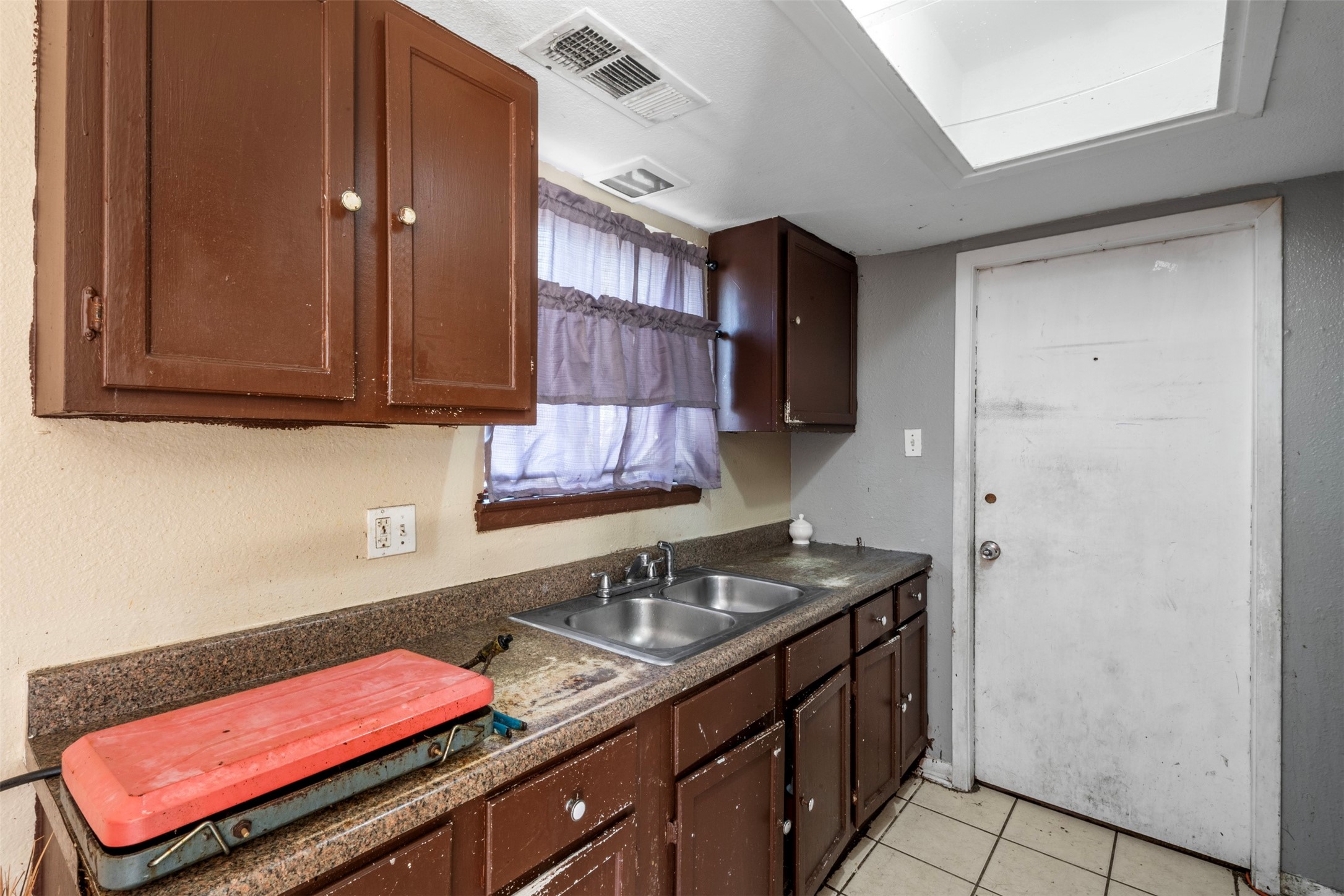 7726 Boggess Road Houston, TX 77016 - Photo 9 of 30 a kitchen with a sink cabinets and utility room