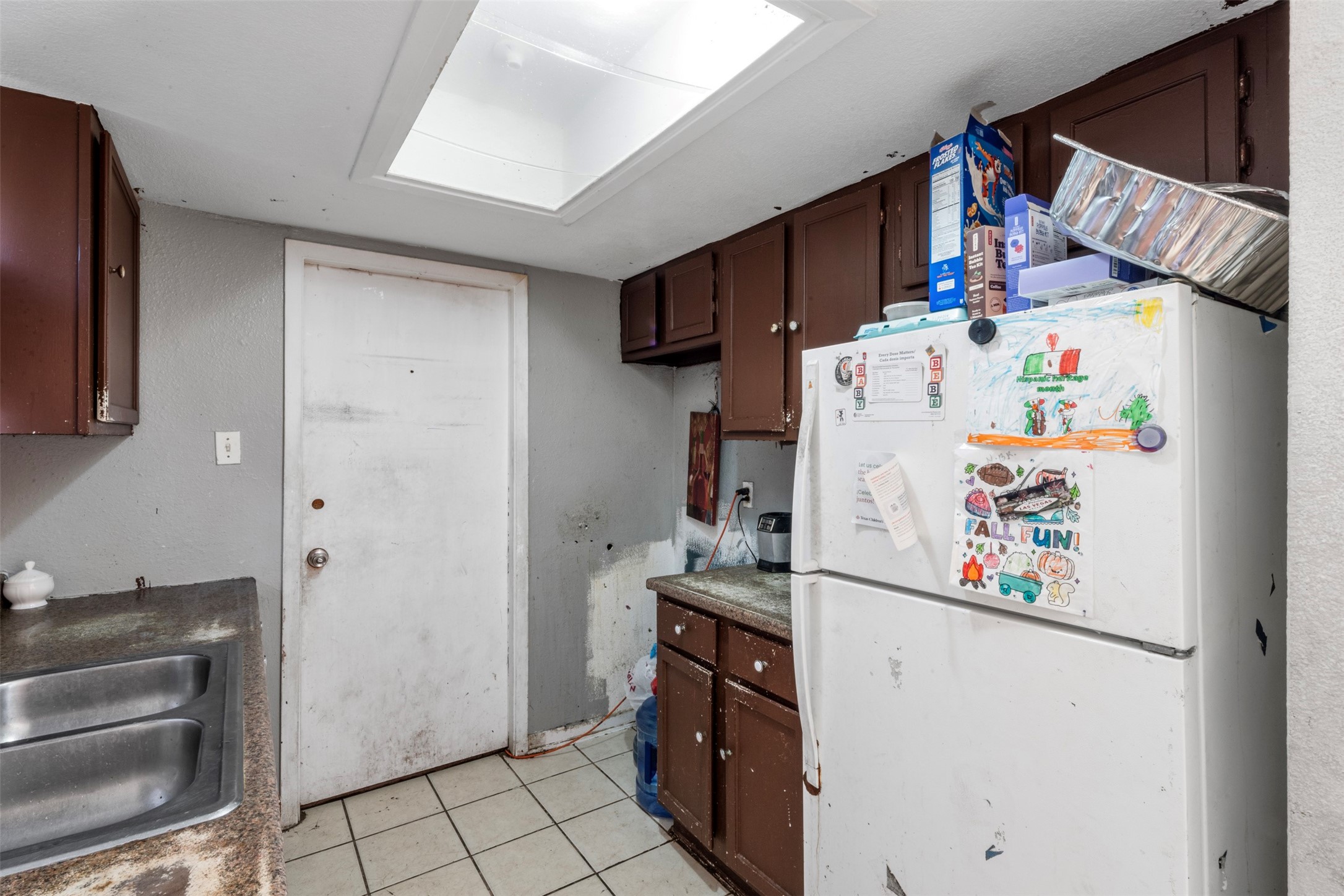 7726 Boggess Road Houston, TX 77016 - Photo 10 of 30 a white refrigerator freezer and a stove sitting inside of a kitchen