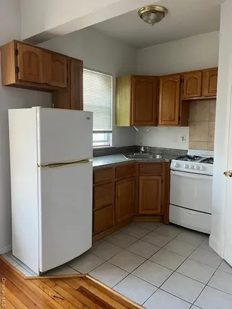 a kitchen with a stove sink and refrigerator