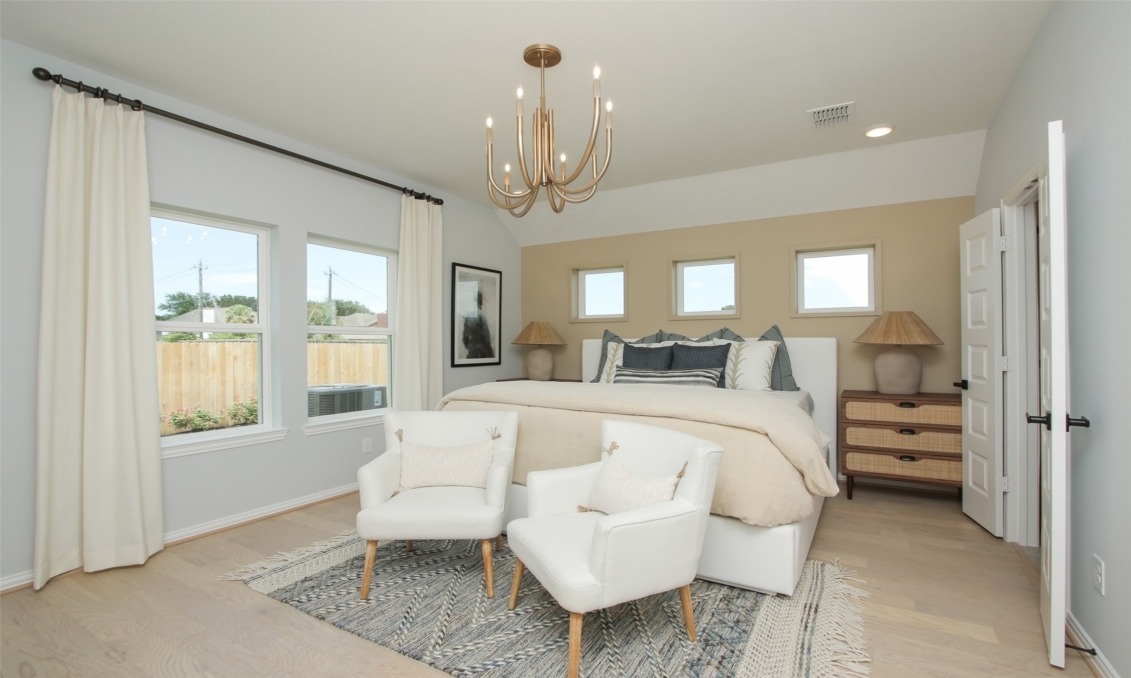2726 Alexis Street Seabrook, TX 77586 - Photo 11 of 31 a spacious bedroom with a bed a chandelier and large window