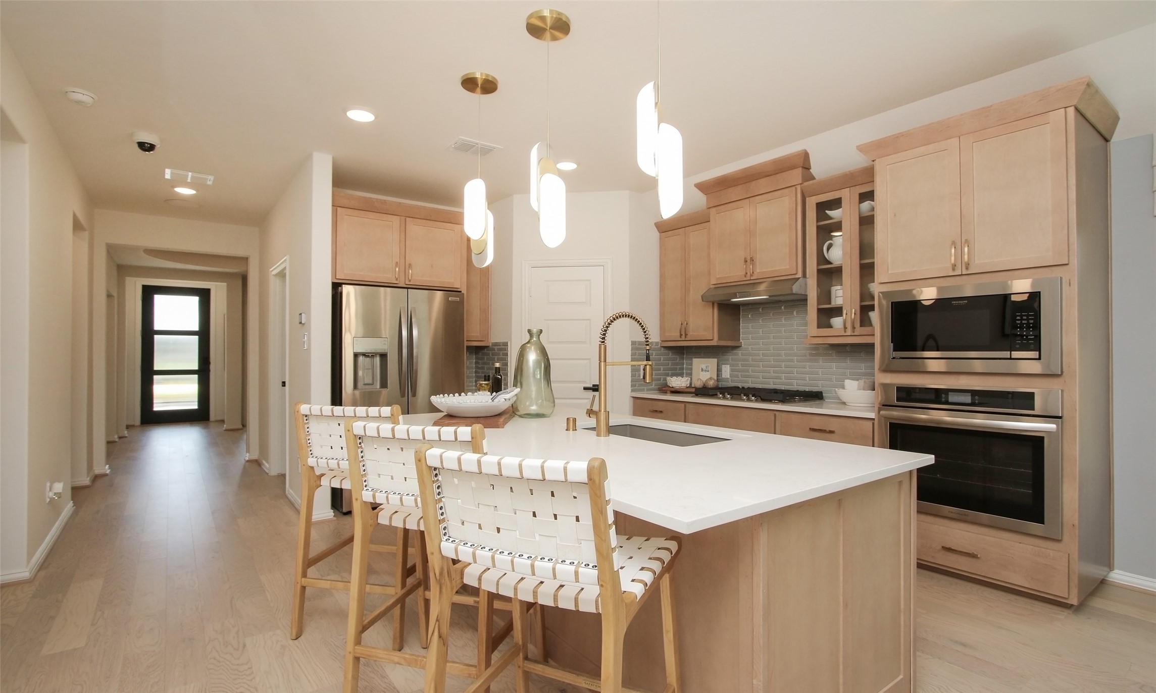 2726 Alexis Street Seabrook, TX 77586 - Photo 5 of 31 a kitchen with stainless steel appliances kitchen island granite countertop a stove a sink a refrigerator a dining table and chairs