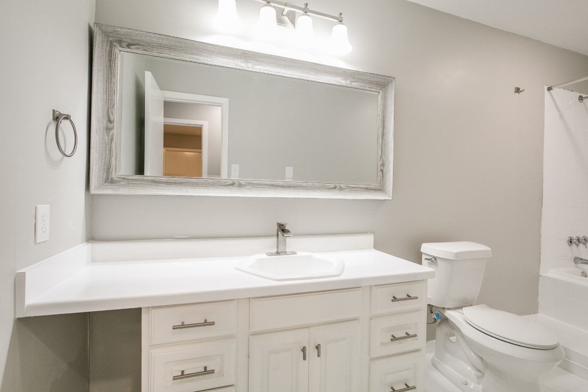 1343 Littleport Lane Channelview, TX 77530 - Photo 19 of 33 a bathroom with a sink a toilet and a mirror