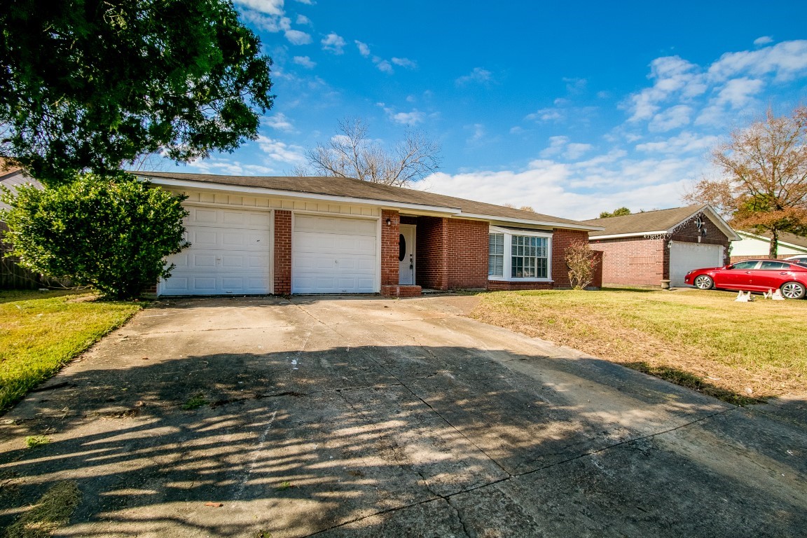 1343 Littleport Lane Channelview, TX 77530 - Photo 2 of 33 a front view of a house with a yard