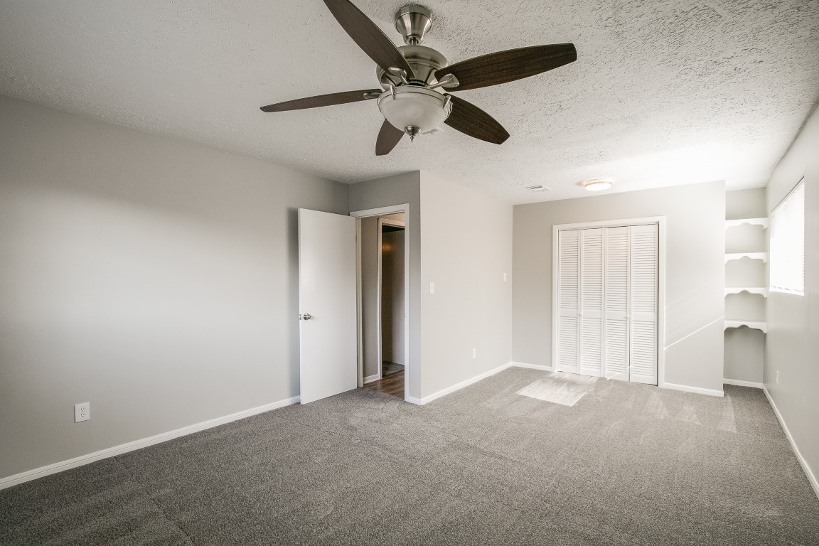 1343 Littleport Lane Channelview, TX 77530 - Photo 27 of 33 en empty room with ceiling fan and window