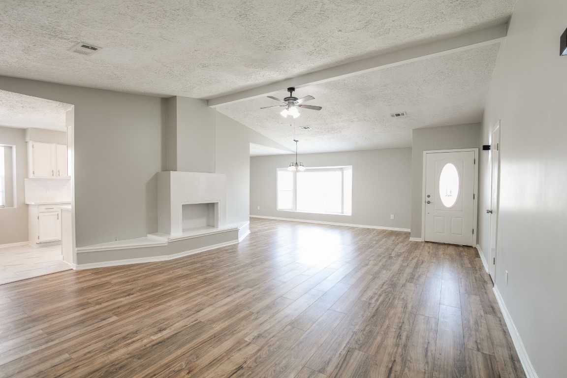 1343 Littleport Lane Channelview, TX 77530 - Photo 4 of 33 wooden floor in an empty room with a window