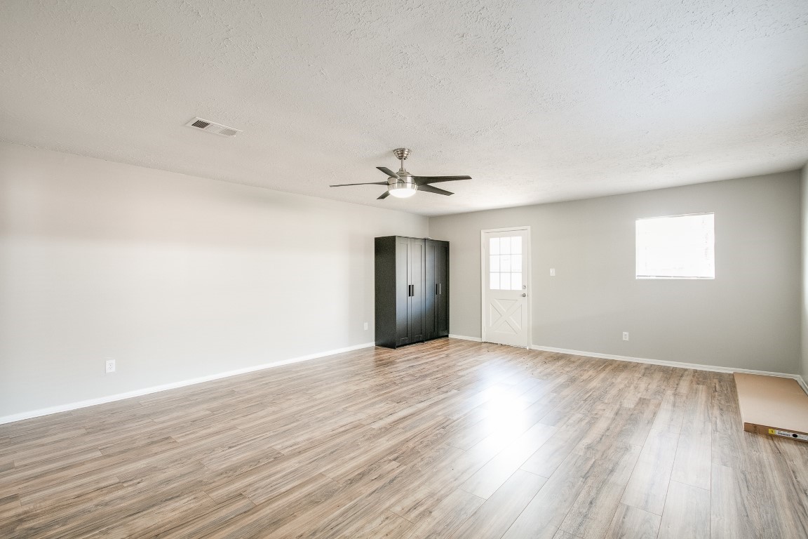 1343 Littleport Lane Channelview, TX 77530 - Photo 6 of 33 an empty room with wooden floor closet and windows