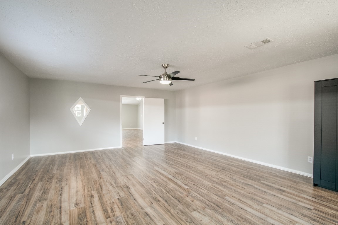 1343 Littleport Lane Channelview, TX 77530 - Photo 8 of 33 wooden floor in an empty room with a window