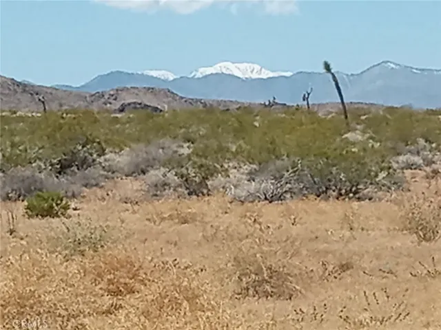 a view of mountain with sunset in background