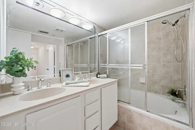 a bathroom with a shower and a sink