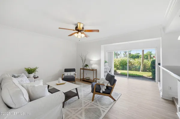 a living room with furniture and kitchen view