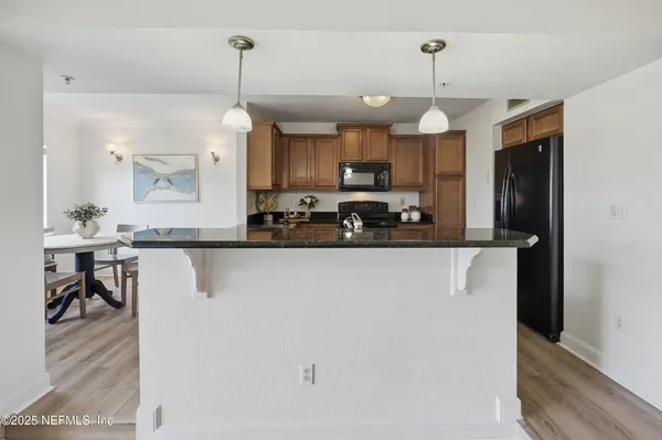 a kitchen with a refrigerator stove and microwave