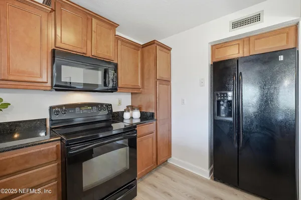 a kitchen with a sink appliances and a counter top