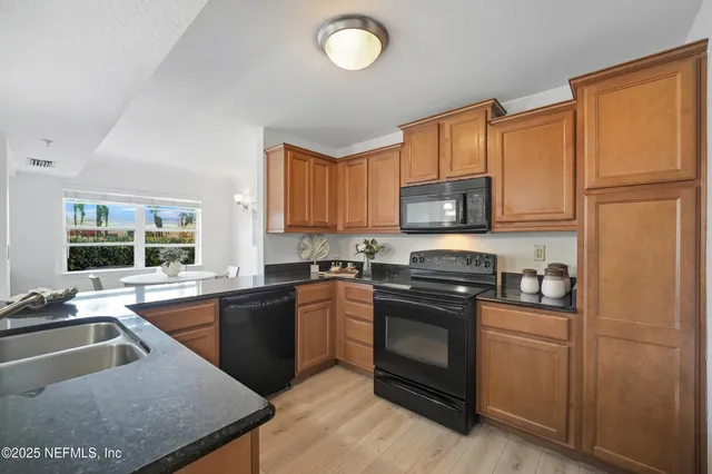 a kitchen with a sink appliances and a counter top