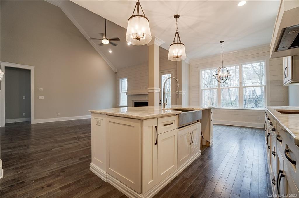 684 Portpatrick Place Fort Mill, SC 29708 - Photo 12 of 25 a kitchen with granite countertop white cabinets and white appliances