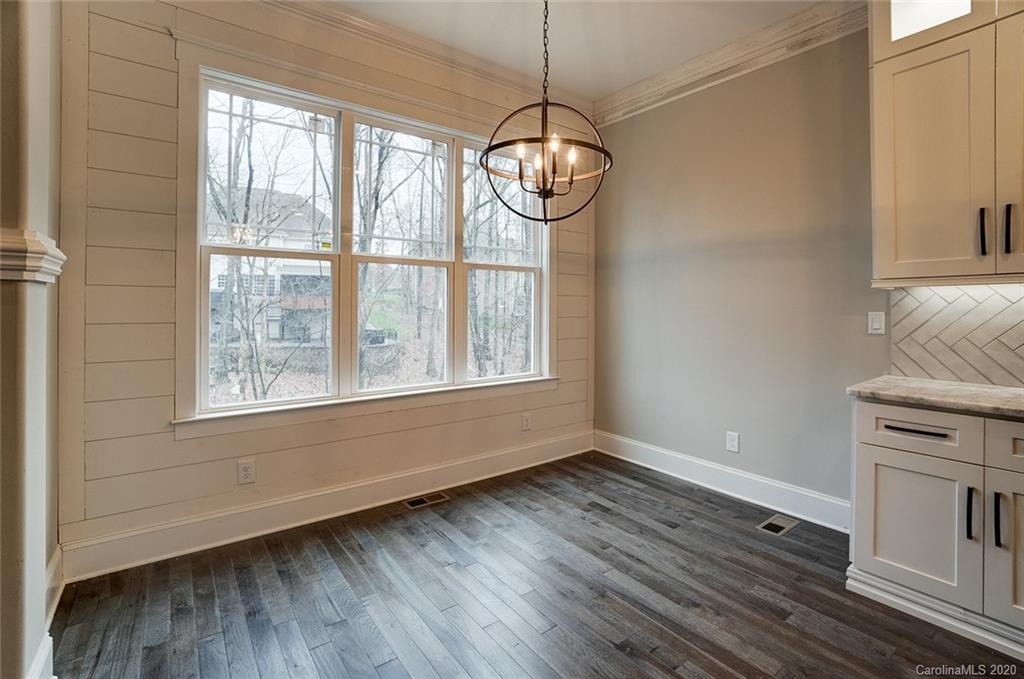 684 Portpatrick Place Fort Mill, SC 29708 - Photo 13 of 25 a view of an empty room with wooden floor and a window