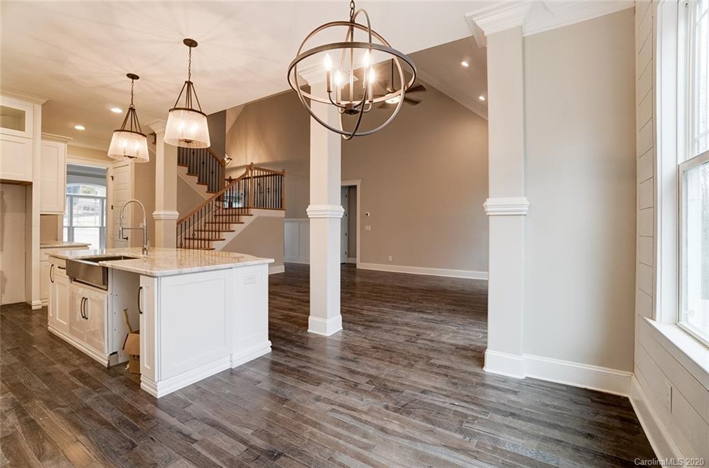 684 Portpatrick Place Fort Mill, SC 29708 - Photo 14 of 25 a kitchen with stainless steel appliances a stove refrigerator and chandelier