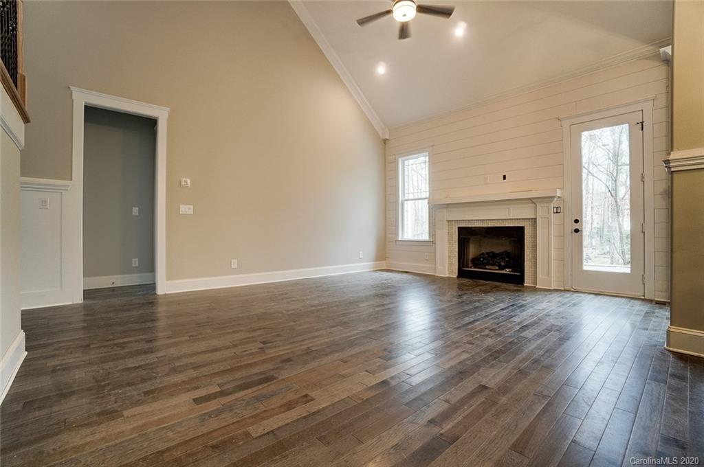 684 Portpatrick Place Fort Mill, SC 29708 - Photo 15 of 25 a view of an empty room with wooden floor fireplace and a window