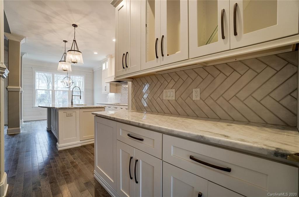 684 Portpatrick Place Fort Mill, SC 29708 - Photo 17 of 25 a kitchen with granite countertop white cabinets and white appliances