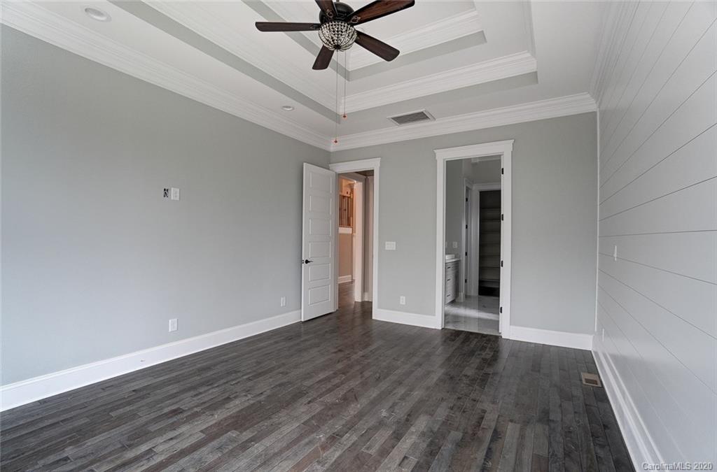 684 Portpatrick Place Fort Mill, SC 29708 - Photo 19 of 25 a view of an empty room with wooden floor