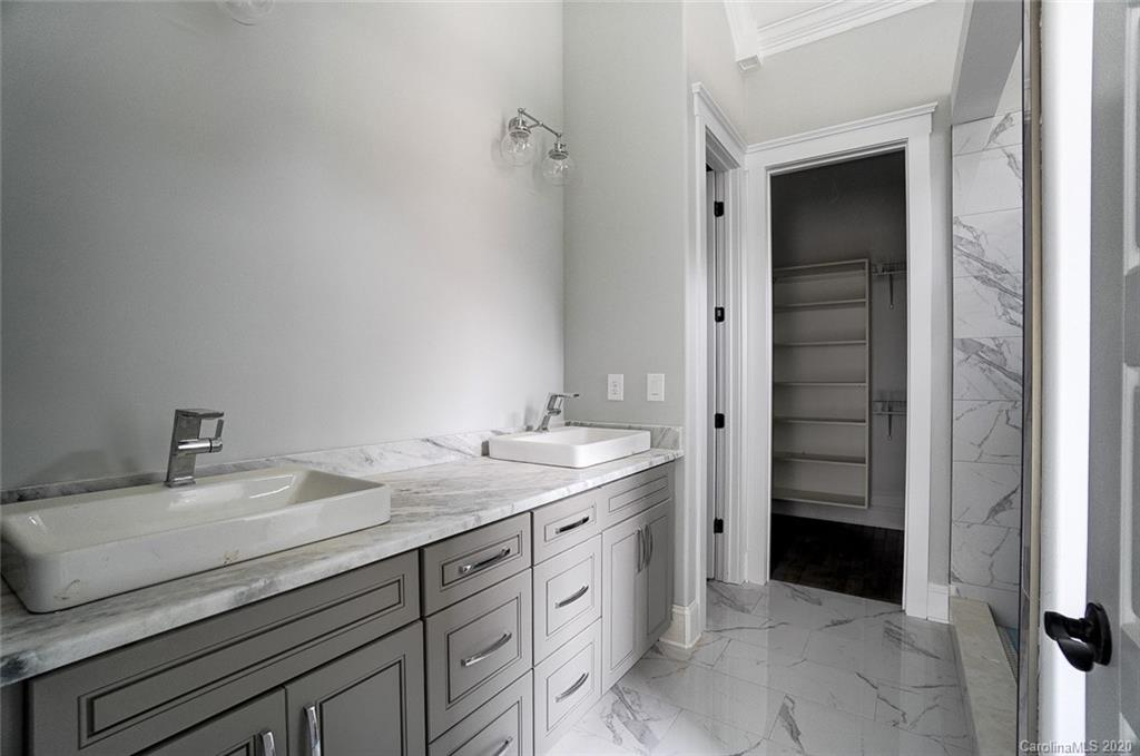 684 Portpatrick Place Fort Mill, SC 29708 - Photo 20 of 25 a spacious bathroom with a granite countertop sink and a mirror