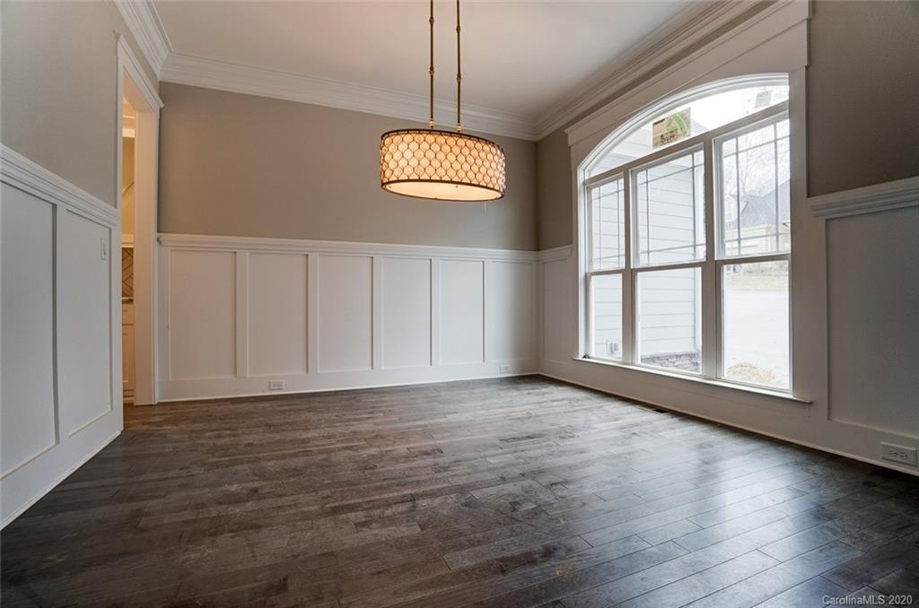 684 Portpatrick Place Fort Mill, SC 29708 - Photo 3 of 25 an empty room with wooden floor and windows