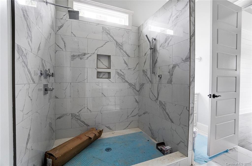 684 Portpatrick Place Fort Mill, SC 29708 - Photo 21 of 25 a bathroom with a tub and a shower