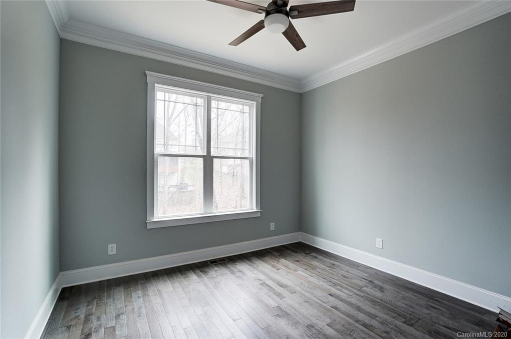 684 Portpatrick Place Fort Mill, SC 29708 - Photo 22 of 25 an empty room with wooden floor fan and windows