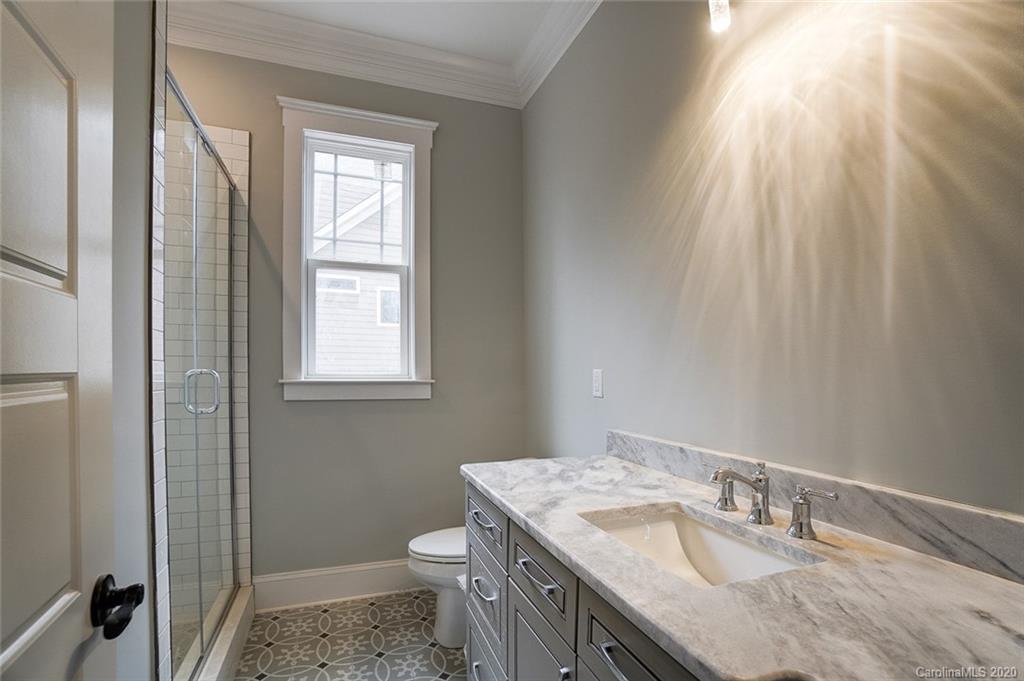 684 Portpatrick Place Fort Mill, SC 29708 - Photo 24 of 25 a bathroom with a granite countertop sink toilet and shower