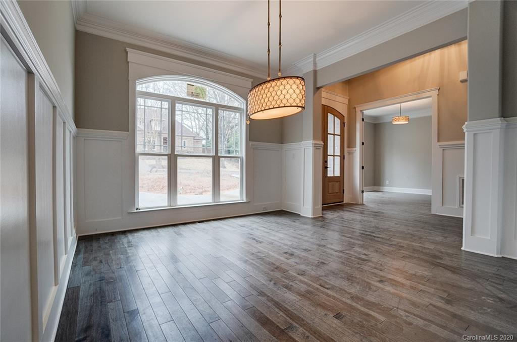 684 Portpatrick Place Fort Mill, SC 29708 - Photo 4 of 25 a view of a room with wooden floor chandelier and windows
