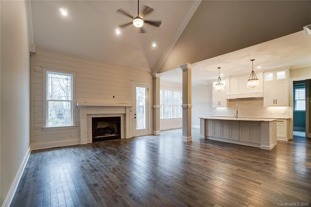 684 Portpatrick Place Fort Mill, SC 29708 - Photo 7 of 25 a view of kitchen and hall with wooden floor and a fireplace