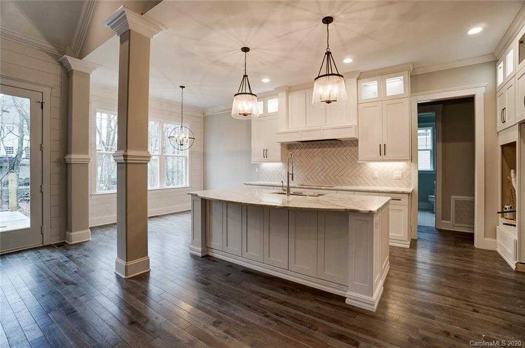 684 Portpatrick Place Fort Mill, SC 29708 - Photo 9 of 25 a view of a kitchen center island wooden floor and a large window