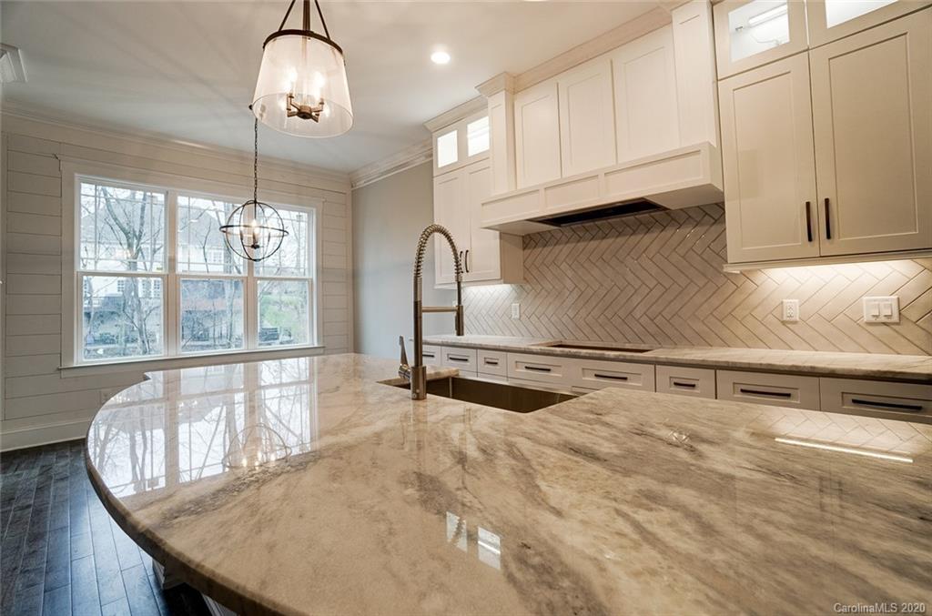 684 Portpatrick Place Fort Mill, SC 29708 - Photo 10 of 25 a kitchen with granite countertop a stove a sink and a granite counter tops