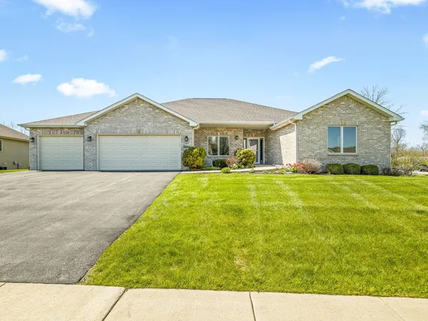 a front view of house with yard and green space