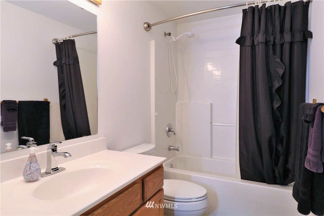 18136 Leitner Road Southwest Rochester, WA 98579 - Photo 22 of 33 a bathroom with a sink a toilet a tub and shower