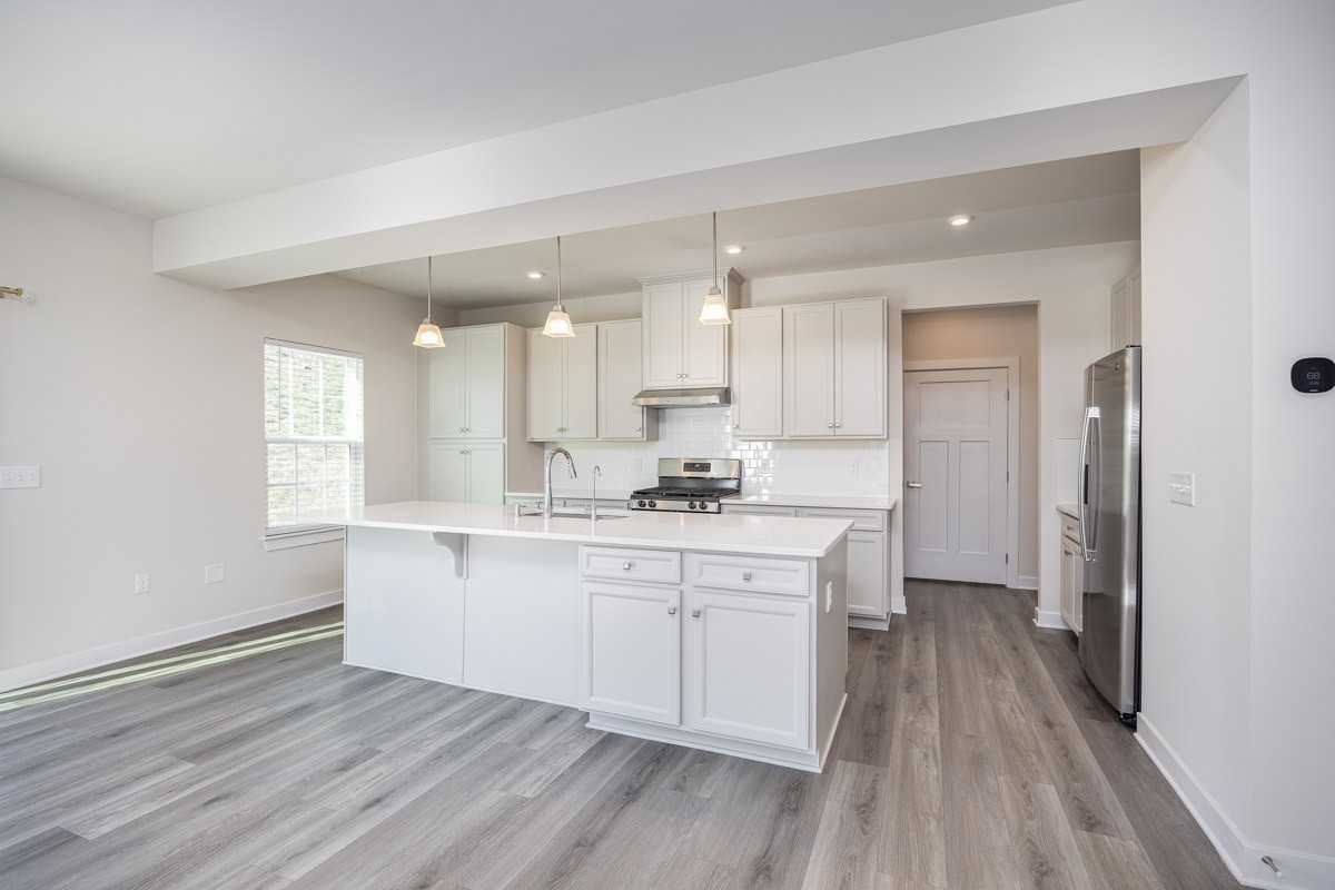 968 Caywood Road Smyrna, TN 37167 - Photo 16 of 54 a large kitchen with a wooden floor and cabinets